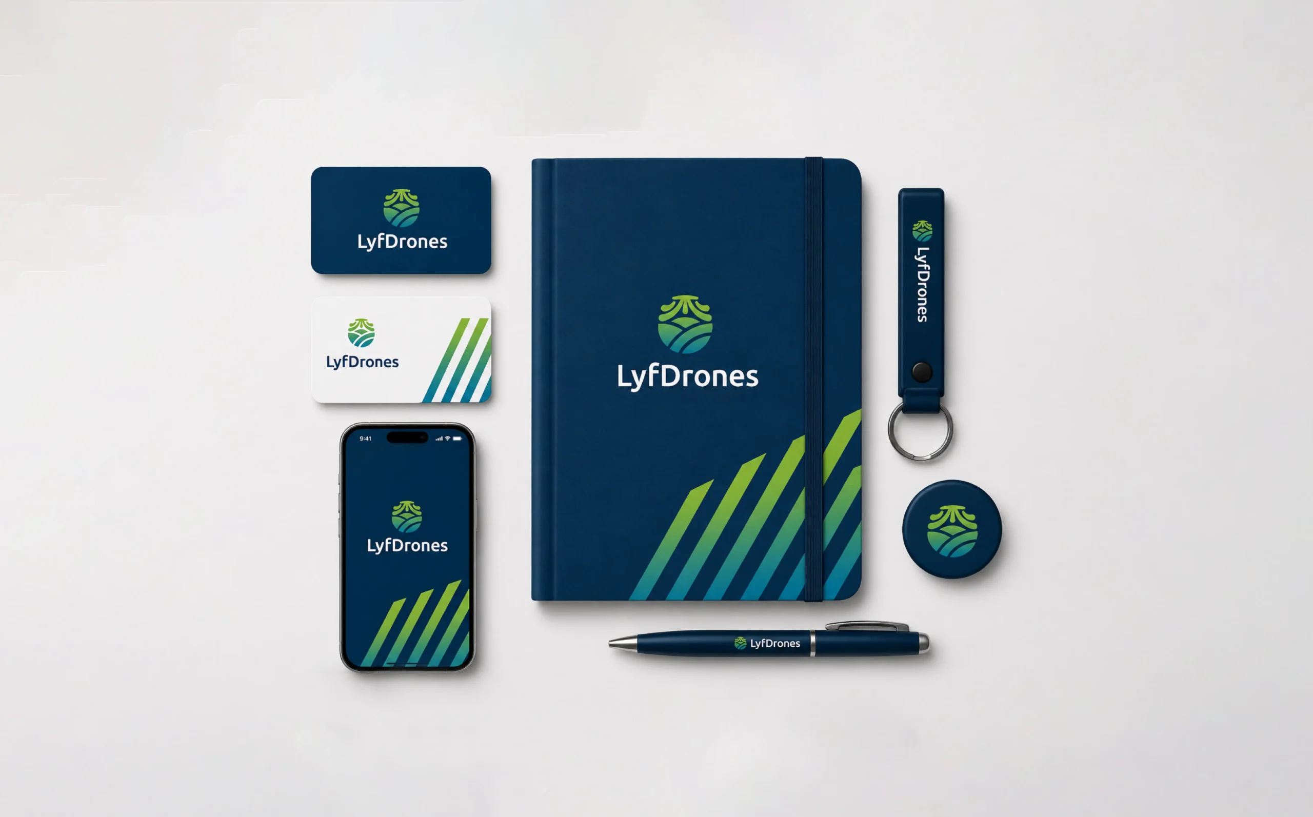 Papelería corporativa de LyfDrones con tarjetas, libreta, lapicero, llavero y aplicación móvil.